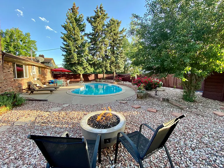 Rock-landscaped backyard with firepit
*pool is covered*