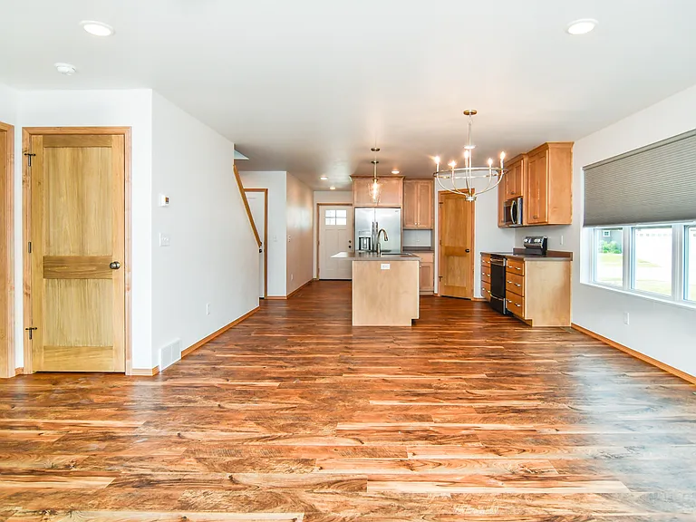 View from living room into dinette, kitchen and entrance to first floor master bedroom