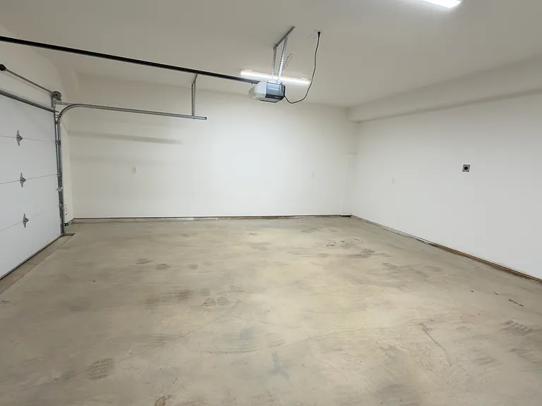 Extra-large two-car garage with EV charger and direct access to the residence foyer.
