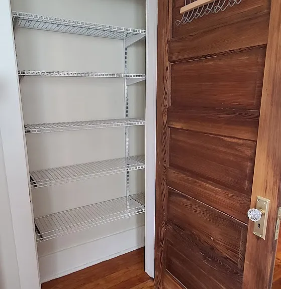 Closet in dining room with adjustable shelves.