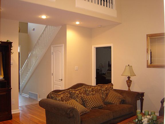 Vaulted Great Room has hardwood floors and corner fireplace