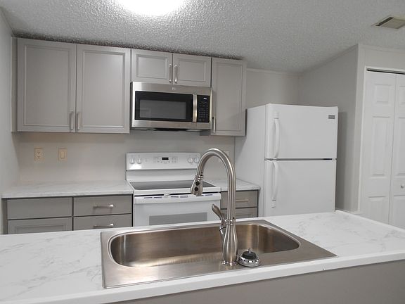 Kitchen features dishwasher, microwave, and pantry for storage.