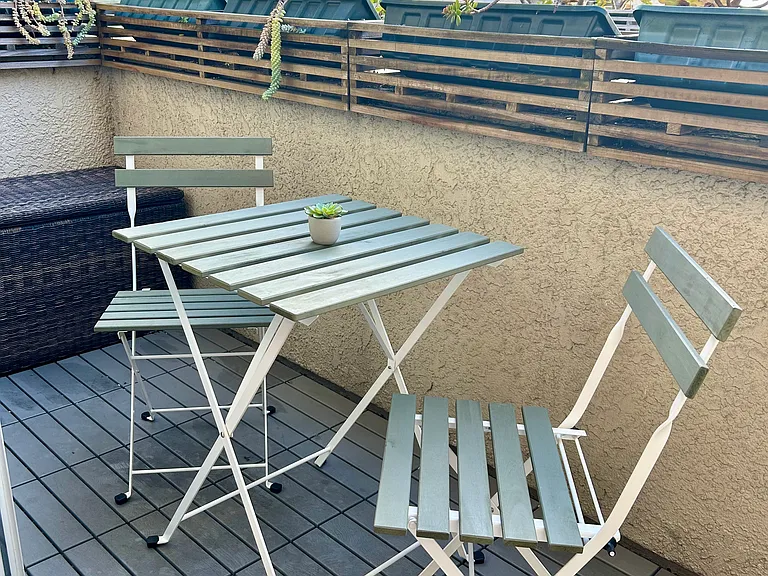 Bistro table on patio adjacent to living room.