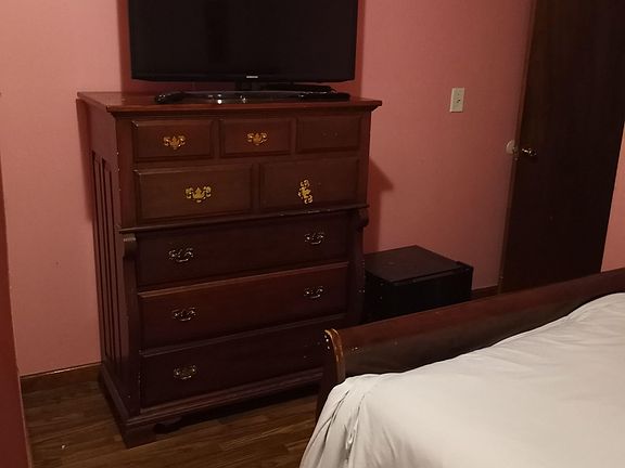 Dresser, Smart TV and mini fridge.