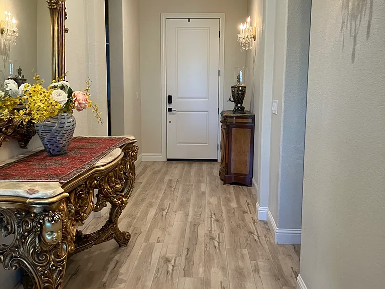 Wide hallway at the entrance. The main area flooring is high-quality vinyl.
