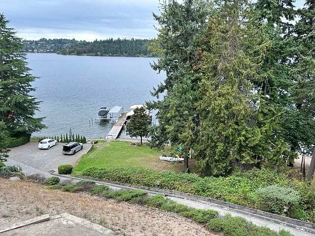 View of waterfront lawn, dock and beach