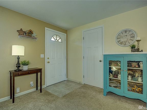Front entry way opening into the living room, with coat closet storage.