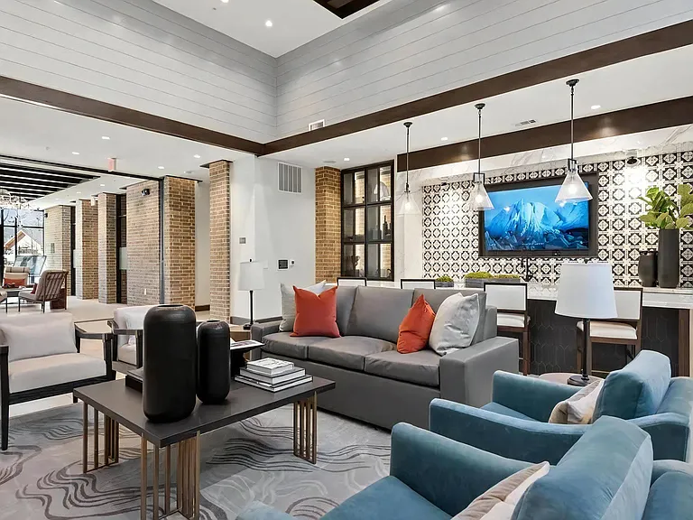Resident Clubroom Featuring TV Wall, Bar Seating & Lounge Area