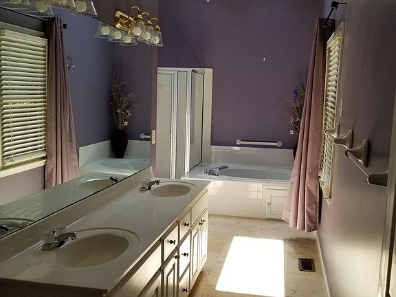 Master bath with separate shower and tub and a water closet