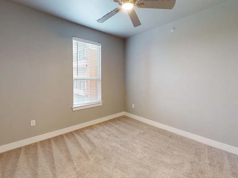 Sling Station's second bedroom includes a ceiling fan and soft carpet. Sling Station's second bedroom includes a ceiling fan and soft carpet.