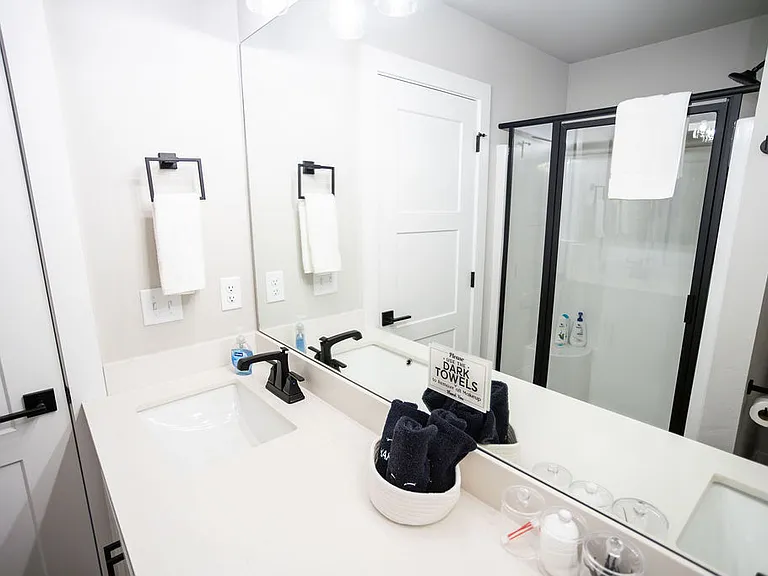 En suite master bathroom has dual sinks, shower, toilet