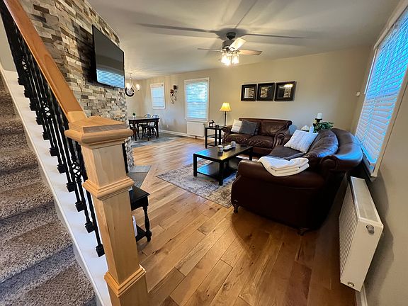 Living room , stairs to second floor and house entrance.