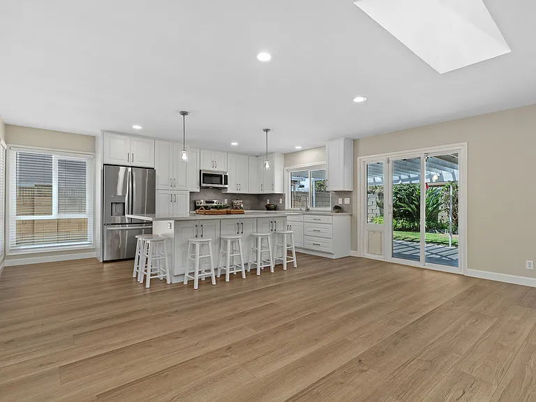 Family Room ~ Kitchen opens to the backyard through sliding glass doors