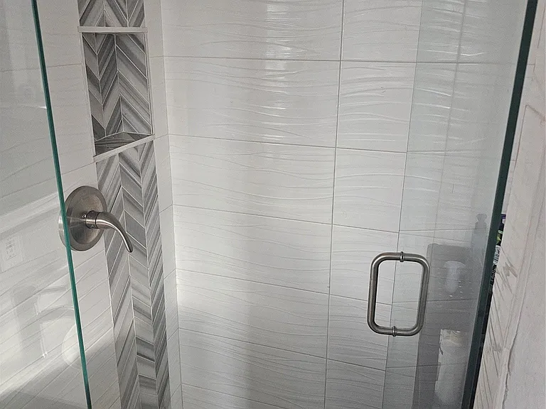 Full bathroom with a shower stall