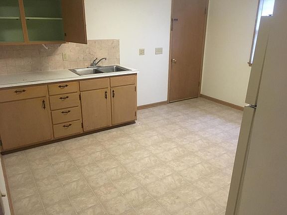Spacious kitchen with appliances.