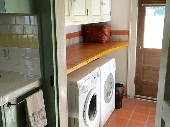 Mud room showing back door and washer and dryer area