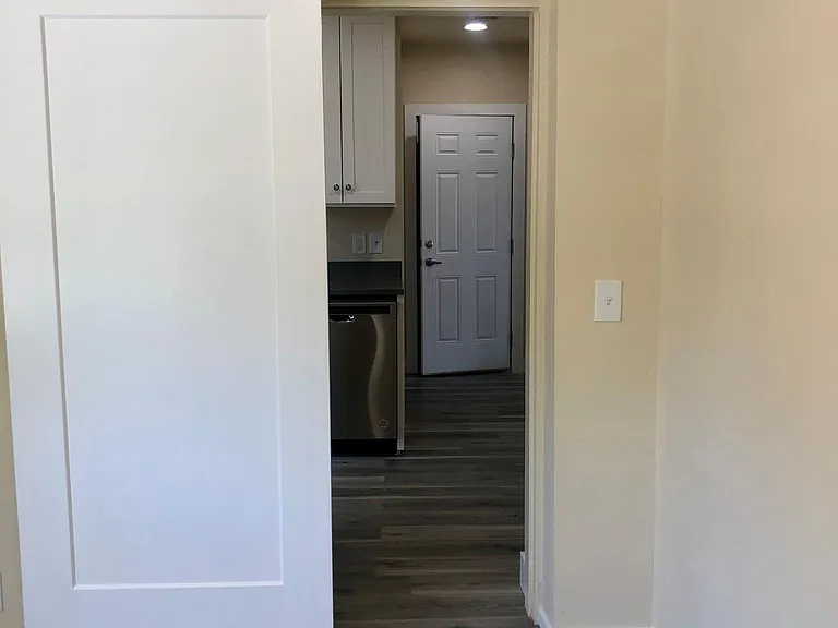 View of entry hallway from side room off the kitchen.