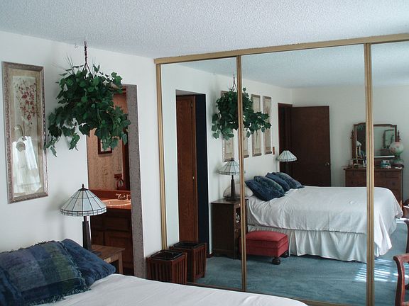 Master bedroom draws soft, filtered afternoon sunlight
