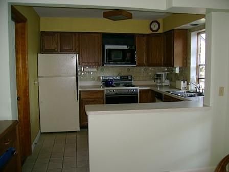 kitchen features oak cabs,ceramic tile floor 