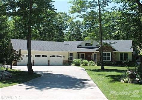 Beautiful view of the 5 bedroom home from the cul-de-sac. Peaceful and private wooded landscape whil