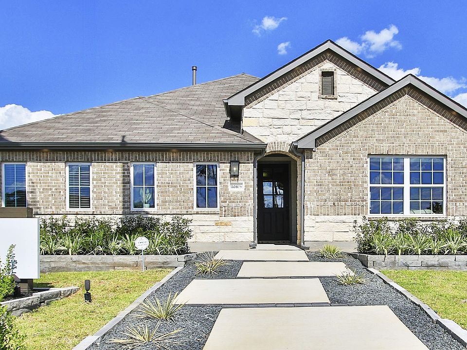 Distinguished single-story home with refined brickwork and gable roofing in the exclusive Cielo encl