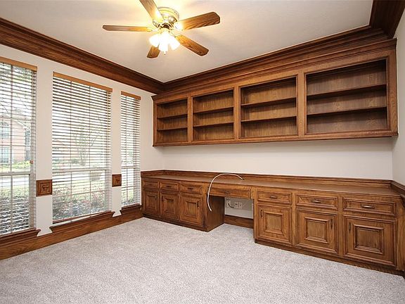 To the left of the entry is the study with french door, beautiful moldings and a built-in desk, cabinets and bookcases. Perfect for a home office!