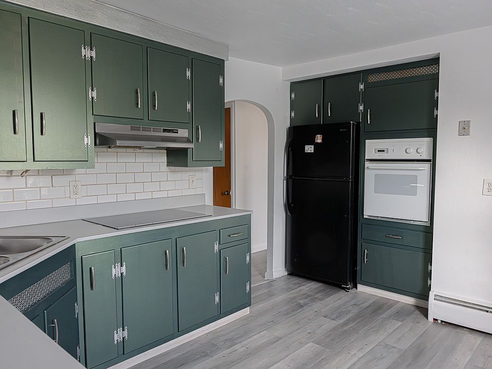 Kitchen features separate wall oven and sleek fridge.
