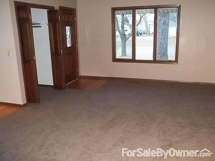 Living Room
						:
						View of front door and coat closet from the living room.