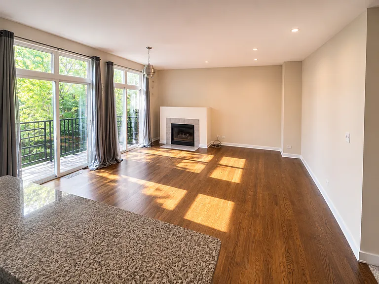 Hardwood flooring throughout the main living area with an open floor concept & a fire place