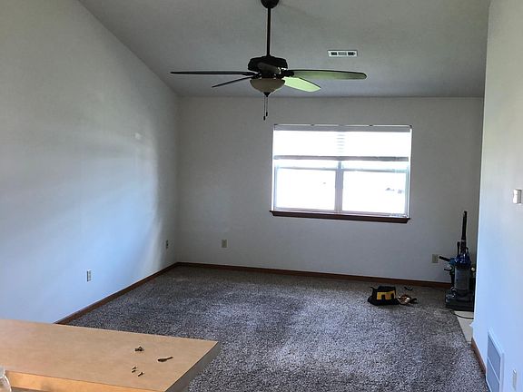 Living Room pic. Carpet - cleaned and ready for move in. Large ceiling fan & vaulted ceilings add volumes of space to the living area.