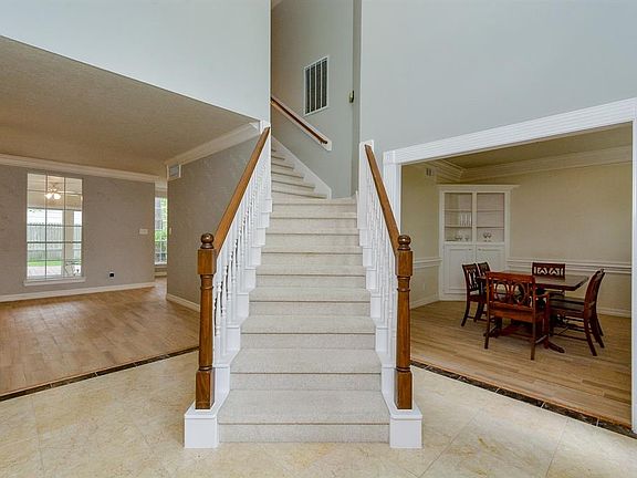 Welcoming formal entry with soaring ceiling and inviting floor plan greets all your guest.