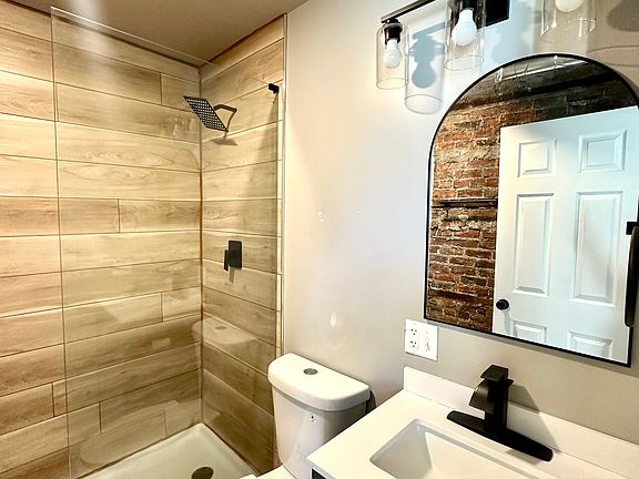 Bathroom with glass shower and rain shower head
