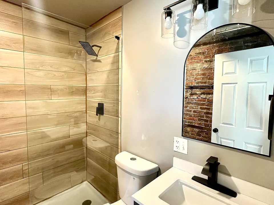 Bathroom with glass shower and rain shower head