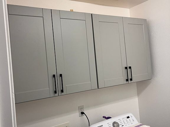Renovated laundry room with new appliances.
