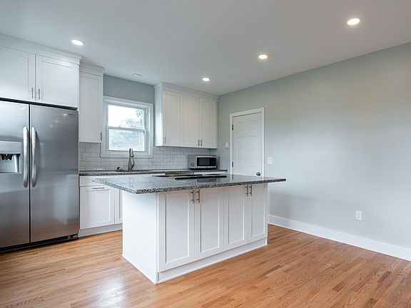 Kitchen view angled (door seen is rear entrance to unit)