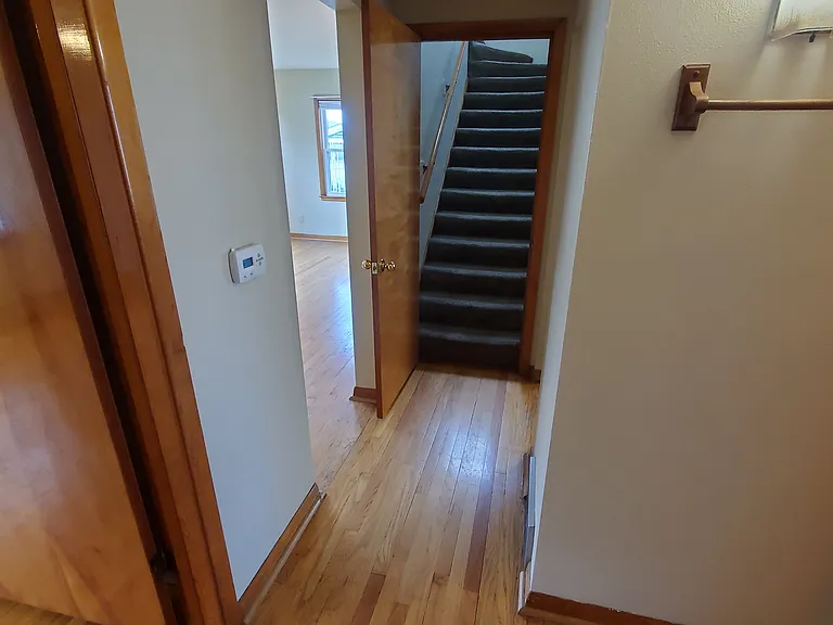 Foyer. Bedroom 1 left doorway. Full bath on right. Family room to left in distance, Bedroom #3 stairs to second floor straight ahead.
