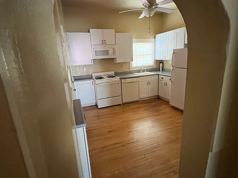 Kitchen with gas stove, dishwasher, microwave and refrigerator. Coffee bar. Room for kitchen table.