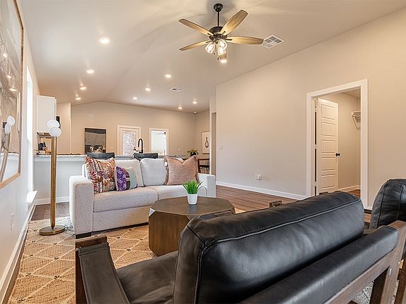 Photo of a furnished living room in the Giselle, one of Betenbough s homes with kitchen peninsula.