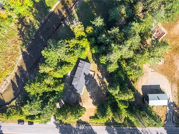 Drone view of property with California Creek bordering to the left