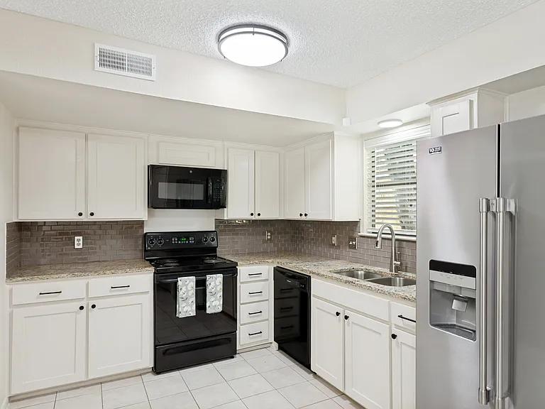 light and bright kitchen with granite counters, new dishwasher and refrigerator