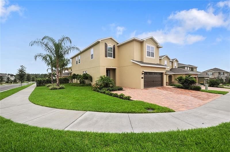 Larger, corner lot with lush landscaping greets your welcome.