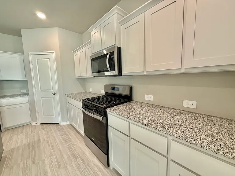 Kitchen with gas range and microwave