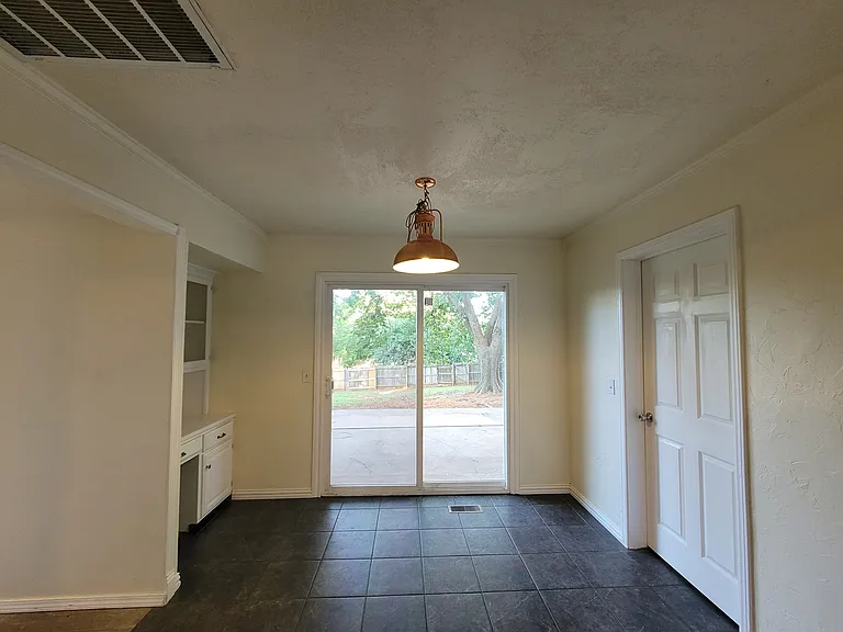 Eatin area of the kitchen with backyard patio access.
