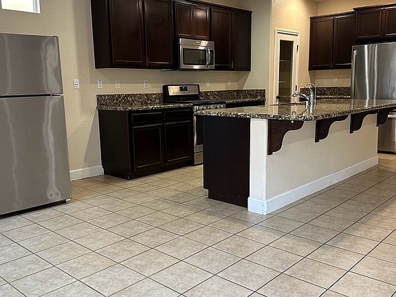 From living room looking into kitchen, with two refrigerators