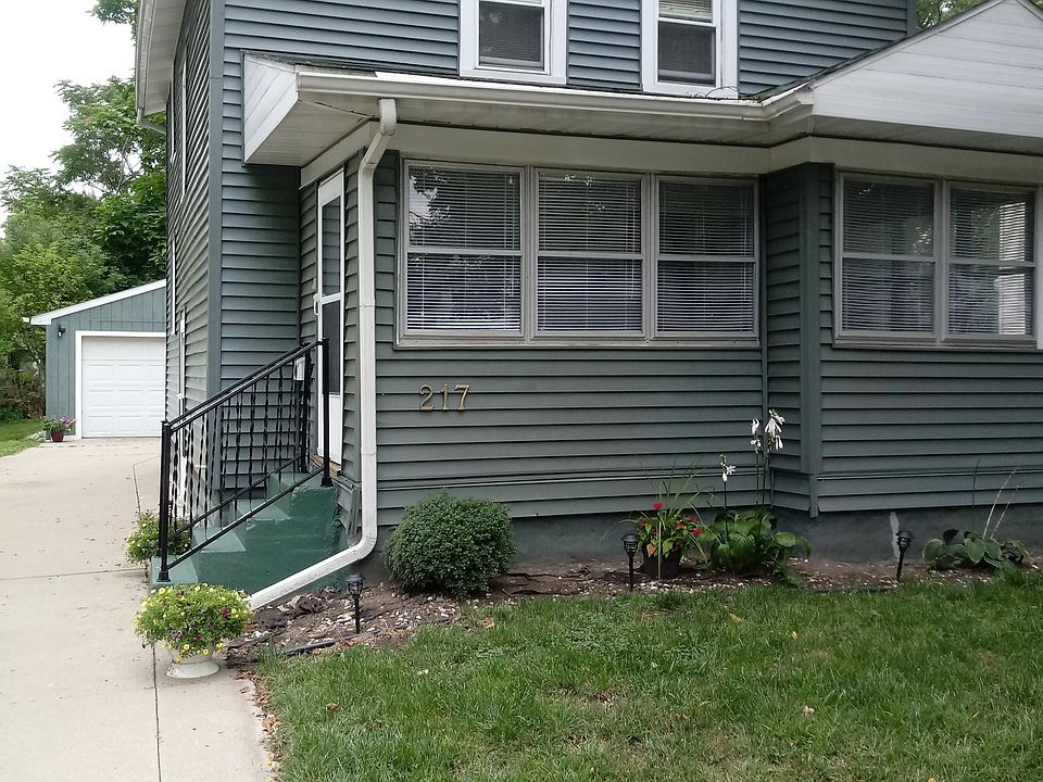House medm green. With white trim 4 season front porch