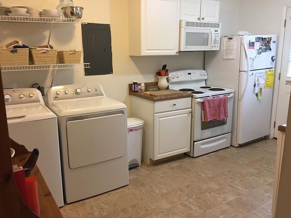 Washer and dryer in kitchen. Range, microwave and refrigerator shown.