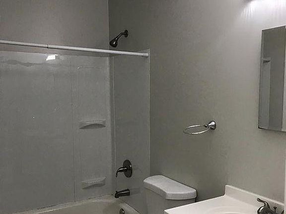 Tub surround and fixtures recently installed, with the low volume flush toilet.