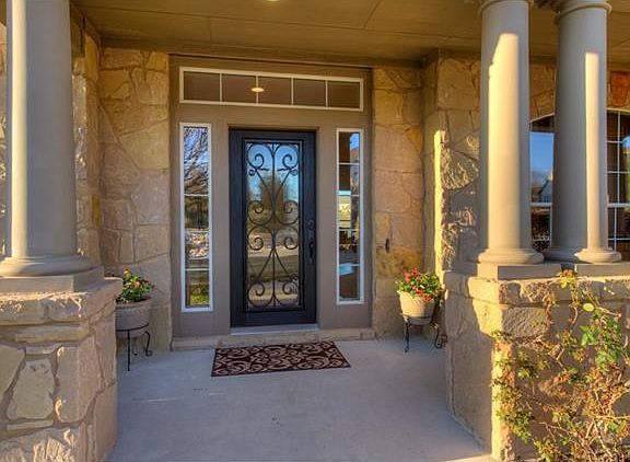 Large front patio, with beautiful entry, and all four sides of the home are stone.