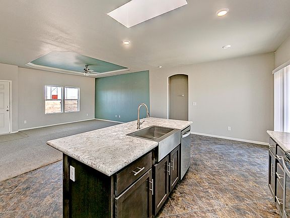 Open & spacious "great room", kitchen, dining area, & living room with 9' flat ceilings, cove ceiling, accent paint, 2" faux wood blinds & ceiling fans.