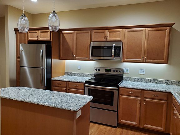 Spacious kitchen with granite countertops and work island.